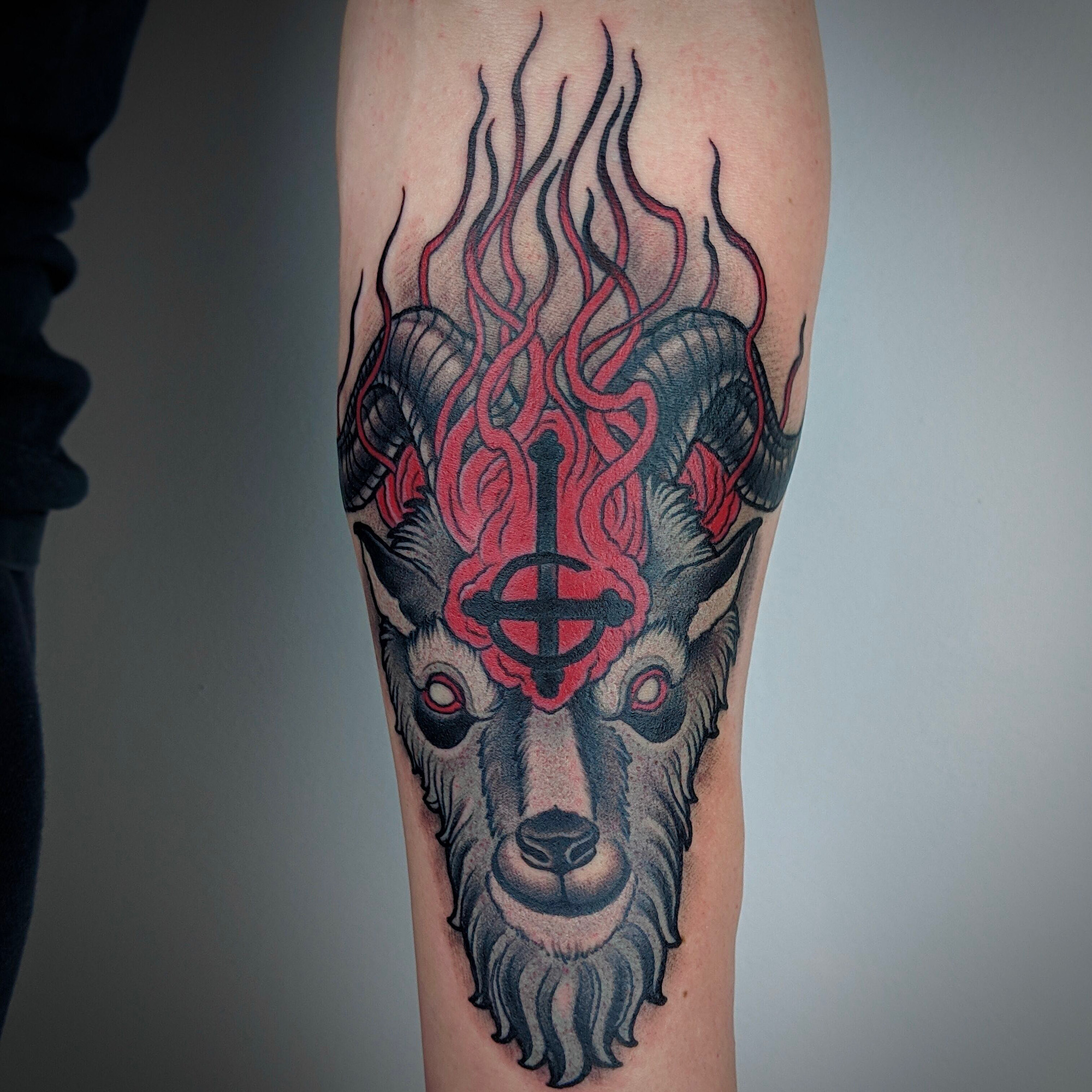 Ghost band logo in a dual tone satanic goat mutton in flames by ricks custom tattooing Ricardo Pedro