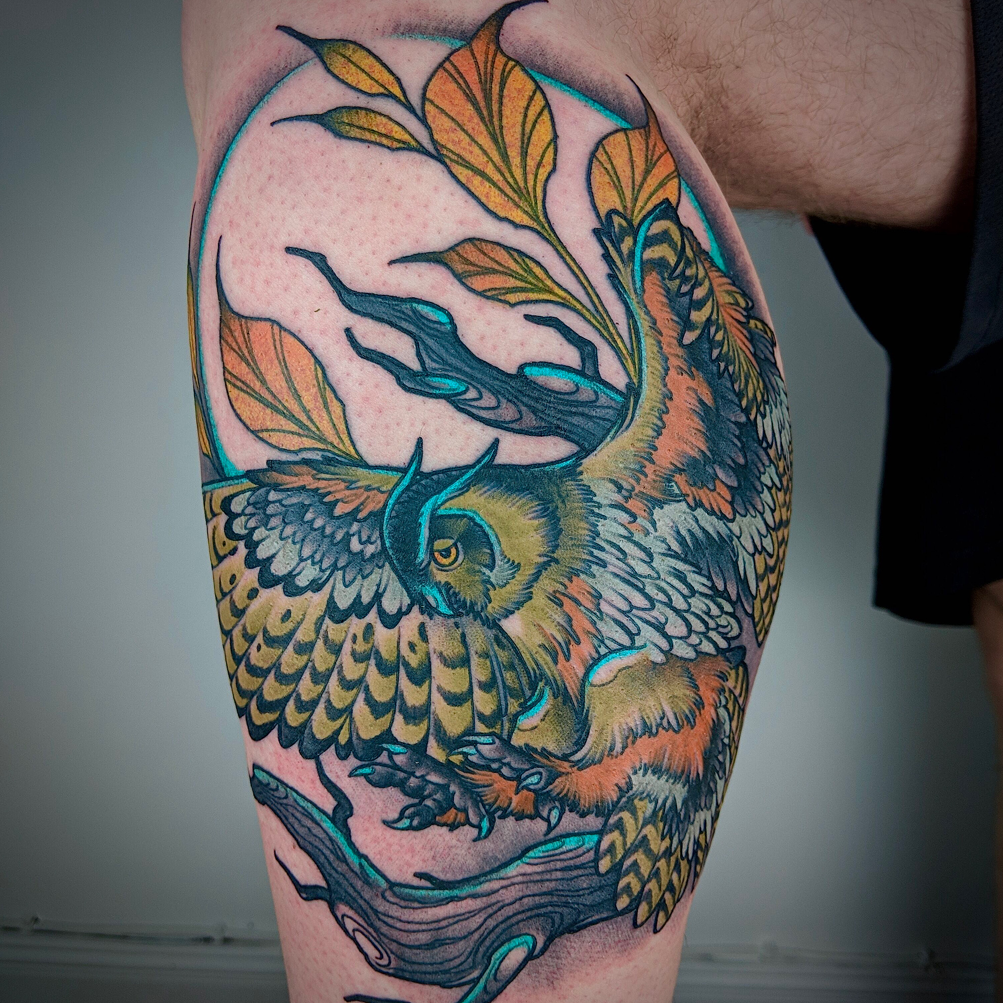 Neo traditional tattoo owl on a branch in colour surrounded by leafs and moon background by Ricks custom tattooing Ricardo Pedro at Nexus Collective
