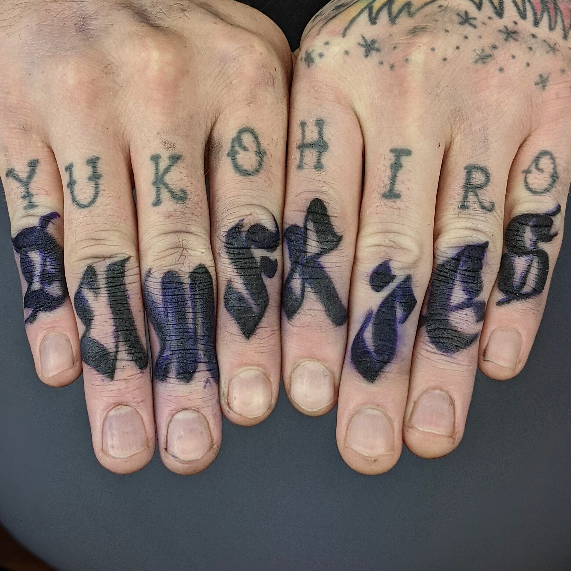 Blackletters old english style lettering dumfries across fingers love letters black and grey gray lettering hand tattoo by Ricks custom tattooing Ricardo Pedro at Nexus Collective